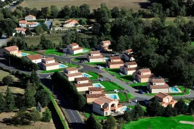 an aerial view of a village with houses and a road at Villas du Golf Domaine Royal Green in Pont-de-Larn
