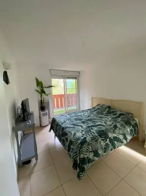 a bedroom with a bed and a window at Villas du Golf Domaine Royal Green in Pont-de-Larn