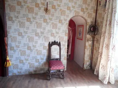 a room with a chair and a mirror on a wall at Logis de La Meschaussée, dans donjon du XIe siècle in Canet d'Aude