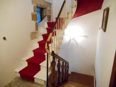 a red and white staircase in a house at Logis de La Meschaussée, dans donjon du XIe siècle in Canet d'Aude