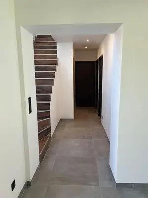 a hallway with a staircase in a house at Villa Catalya moderne piscine chauffée in Carcassonne