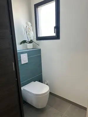 a bathroom with a white toilet and a window at Villa Catalya moderne piscine chauffée in Carcassonne