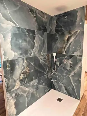 a bathroom with a marble wall with a white table at Villa Catalya moderne piscine chauffée in Carcassonne