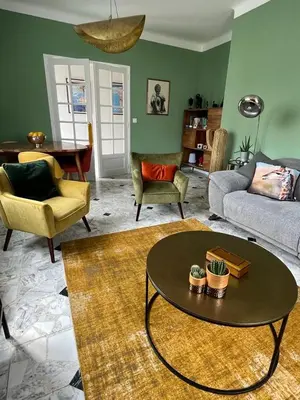 a living room with a couch and a table and chairs at Maison de charme avec jardin in Carcassonne