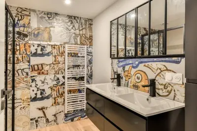 a bathroom with a sink and a mosaic wall at Villa Terracotta - 8 Personnes - Proche de la mer in Peyriac-de-Mer