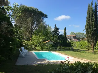 a swimming pool in the yard of a house at Maison du Breilh in Mirepoix