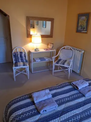 a living room with a couch and two chairs at Maison du Breilh in Mirepoix