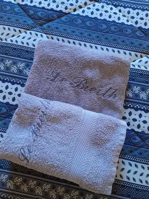 a close up of two napkins on a quilt at Maison du Breilh in Mirepoix
