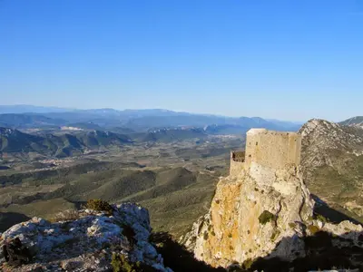 a castle on the top of a mountain at La romance. in Prugnanes