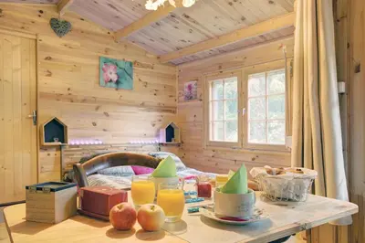 a wooden room with a table with fruit and juice at La romance. in Prugnanes