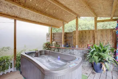 a hot tub on a patio with a wooden deck at La romance. in Prugnanes