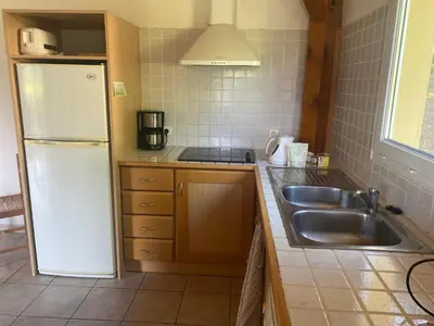 a kitchen with a white refrigerator and a sink at Charming house in Espinet domain in Quillan