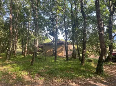 a tent in the middle of a forest with trees at Charming house in Espinet domain in Quillan
