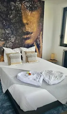 a bedroom with a bed with towels on it at Loft & spa d'Autan in Villefranche-de-Lauragais
