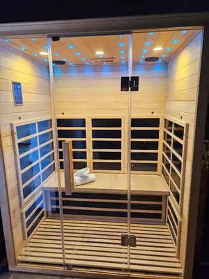 a sauna with wooden walls and shelves in a room at Loft & spa d'Autan in Villefranche-de-Lauragais