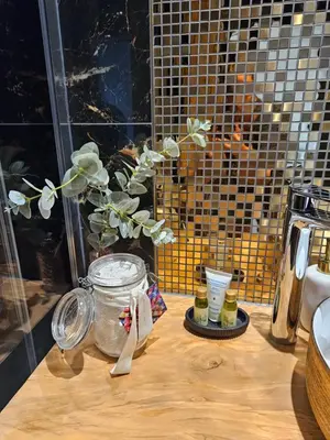 a table with a glass jar with a plant in it at Loft & spa d'Autan in Villefranche-de-Lauragais