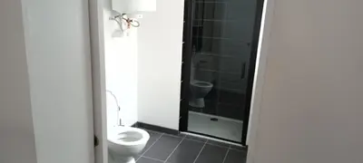 a bathroom with a toilet and a walk in shower at Le bon coin jardin acces autonomie parking privé in Castres