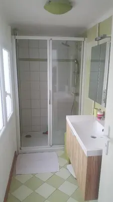 a bathroom with a shower and a sink and a tub at Maison de village in Saint-Hilaire