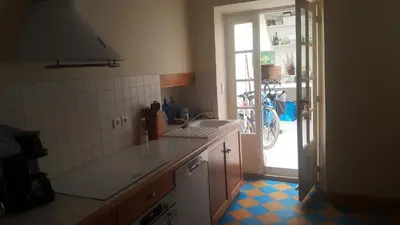 a kitchen with a sink and a counter top at Maison de village in Saint-Hilaire