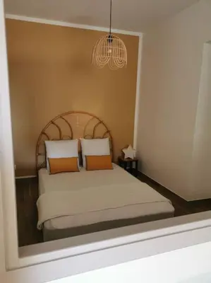 a bedroom with a bed with a reflection in a mirror at L'althea in Carcassonne
