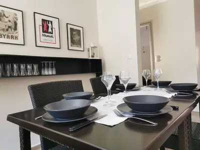 a table with bowls and plates and wine glasses at L'althea in Carcassonne