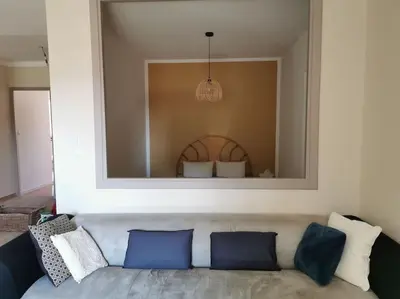 a living room with a couch with a large mirror at L'althea in Carcassonne