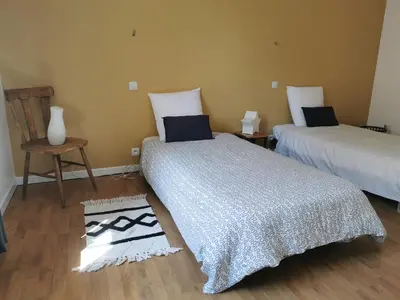 a room with two beds and a table and a chair at L'althea in Carcassonne