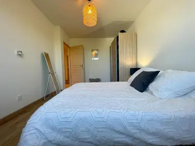 a bedroom with a large white bed in a room at Villa La Paz ※ Climatisée in Lézignan-Corbières