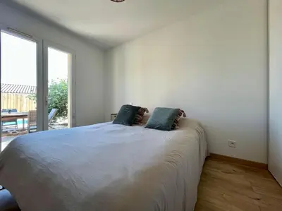 a white bedroom with a large bed with two pillows at Villa La Paz ※ Climatisée in Lézignan-Corbières