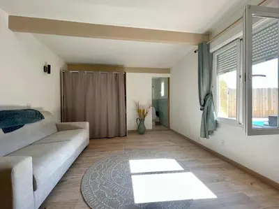 a living room with a couch and a window at Villa La Paz ※ Climatisée in Lézignan-Corbières