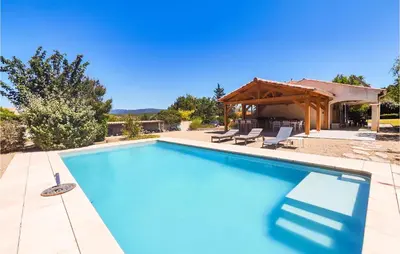 a swimming pool in front of a house at Beautiful Home In Prades-Sur-Vernazobre in Prades-sur-Vernazobre