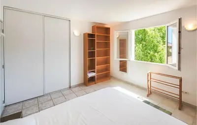 a bedroom with a bed and a window at Beautiful Home In Prades-Sur-Vernazobre in Prades-sur-Vernazobre