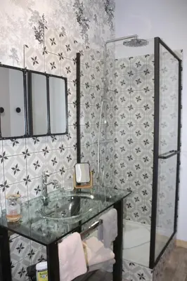 a bathroom with a glass sink and a shower at Gîte La Tchoupetta in Peyriac-de-Mer