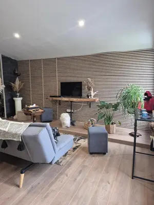 a living room with a couch and a tv at Gîte La Tchoupetta in Peyriac-de-Mer