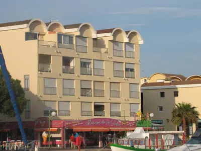 a large building with arches on the side of it at Studio Gruissan Vue Port in Gruissan