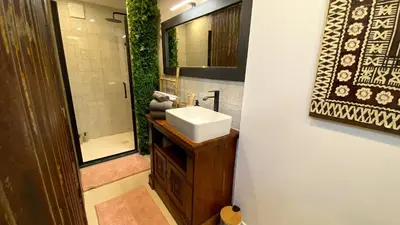a bathroom with a sink and a mirror at Tropical Lodge SPA Narbonne in Narbonne