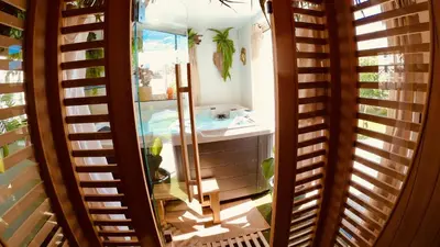 a bathroom with a sink and a mirror at Tropical Lodge SPA Narbonne in Narbonne