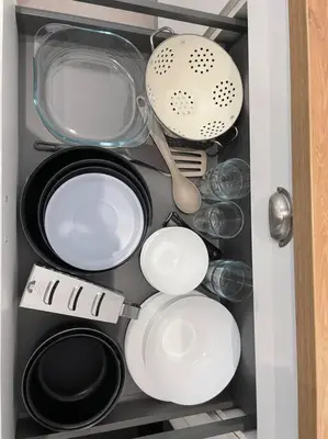 a drawer filled with pots and pans and utensils at Magnifique appartement Narbonne in Narbonne