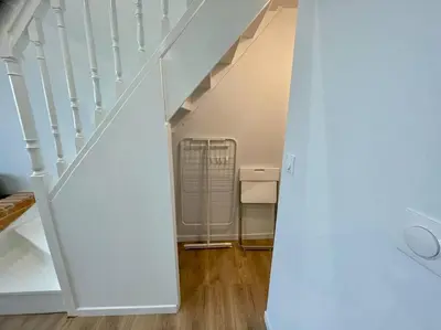 a room with a staircase with a fan in it at Magnifique appartement Narbonne in Narbonne