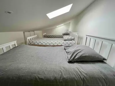 a bedroom with two beds and a skylight at Magnifique appartement Narbonne in Narbonne