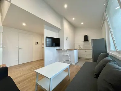 a living room with a couch and a table at Magnifique appartement Narbonne in Narbonne