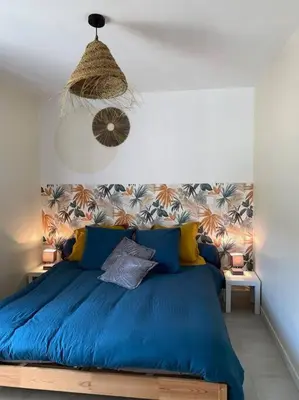 a bedroom with a blue bed in a room at Casa del Sola in Mosset