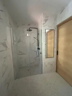 a bathroom with a shower with a glass door at Casa del Sola in Mosset