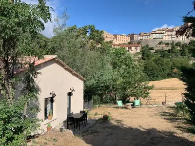 a small white house in the middle of a field at Casa del Sola in Mosset