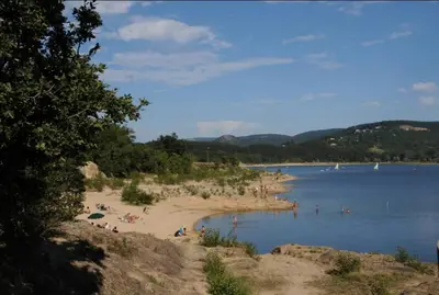 a group of people on a beach in the water at Gîte de France Chez Fati in Les Brunels