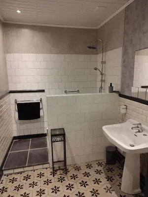 a bathroom with a sink and a tub and a sink at La Scierie in Quillan