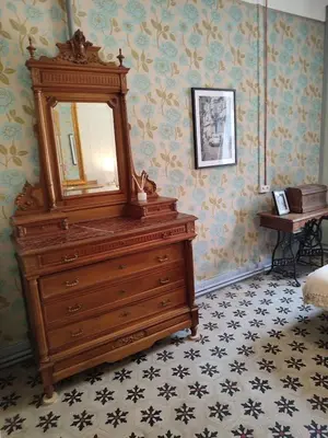 a dresser with a mirror on top of it in a room at La Scierie in Quillan