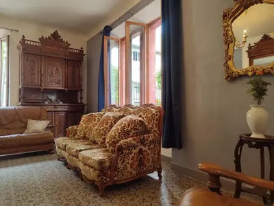 a living room with a couch and a mirror at La Scierie in Quillan
