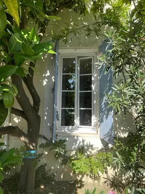 a door to a house with a window at Du côté de chez nous in Cuxac-dʼAude