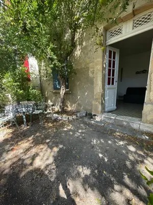 a house with a bench in front of a door at Du côté de chez nous in Cuxac-dʼAude